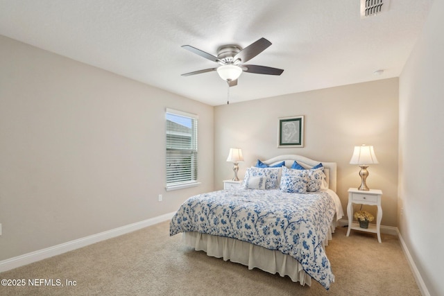 bedroom with light carpet, visible vents, and baseboards