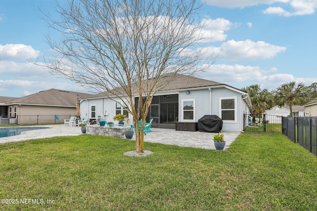 rear view of house with a yard, a fenced backyard, a sunroom, and a patio