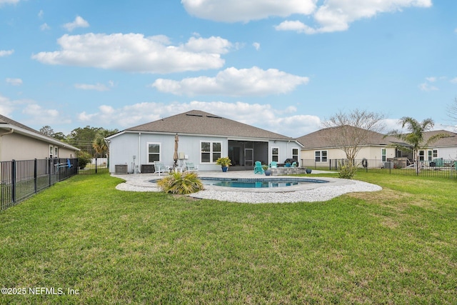 rear view of house with a fenced in pool, a fenced backyard, a yard, a patio area, and stucco siding