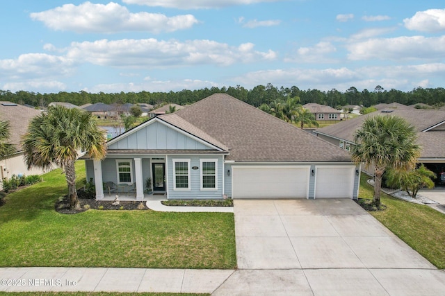 view of front of house featuring covered porch, concrete driveway, an attached garage, board and batten siding, and a front yard