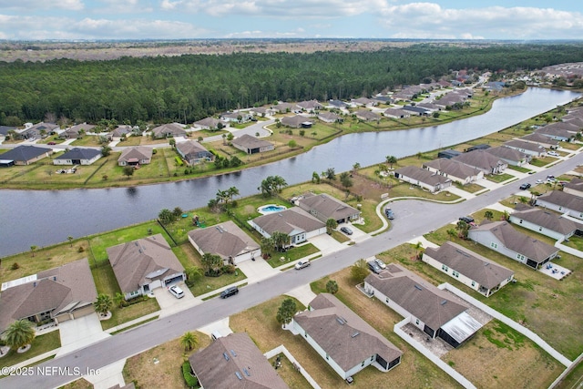 drone / aerial view with a water view and a residential view