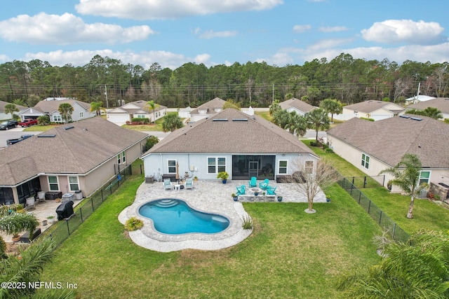 exterior space featuring a residential view, a patio area, a fenced backyard, and a lawn