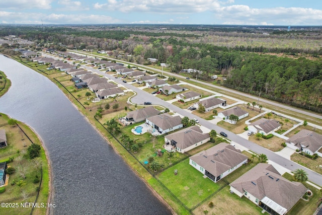 birds eye view of property with a water view and a residential view