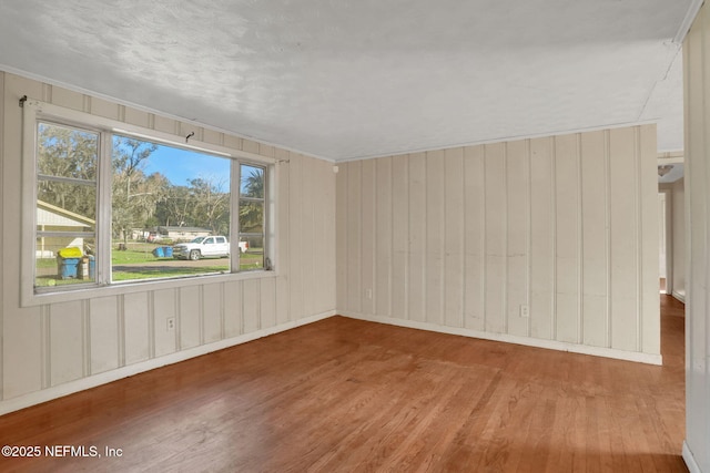 unfurnished room with wood finished floors