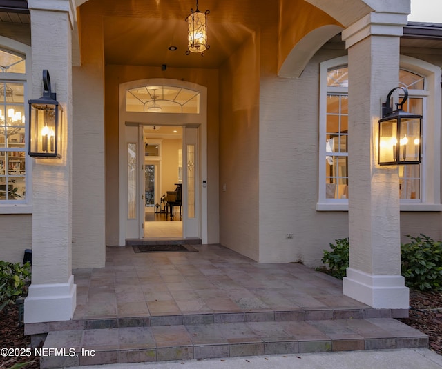 entrance to property featuring stucco siding