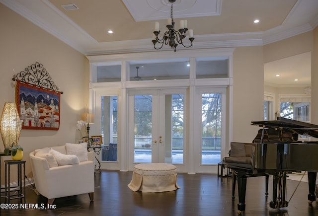 entryway featuring ornamental molding, french doors, dark wood finished floors, and a healthy amount of sunlight