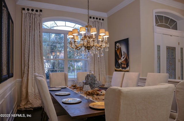 dining area featuring ornamental molding, a decorative wall, a wealth of natural light, and a notable chandelier