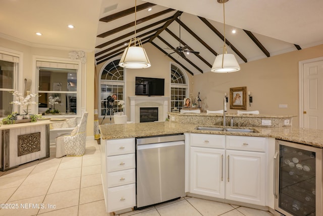 kitchen with dishwasher, wine cooler, light stone counters, open floor plan, and a sink