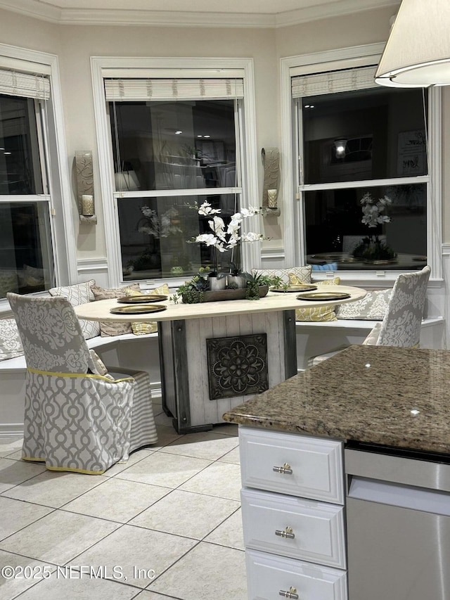 bar with light tile patterned floors and ornamental molding