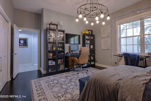 bedroom featuring baseboards and wood finished floors