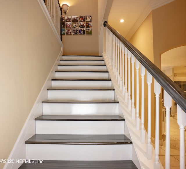 stairway with recessed lighting and crown molding