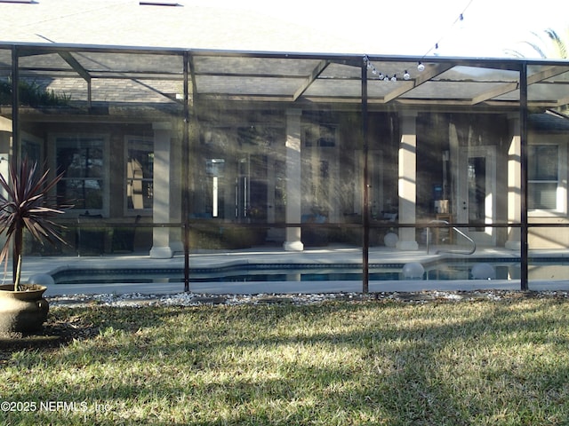 view of exterior entry featuring a patio area and an outdoor pool