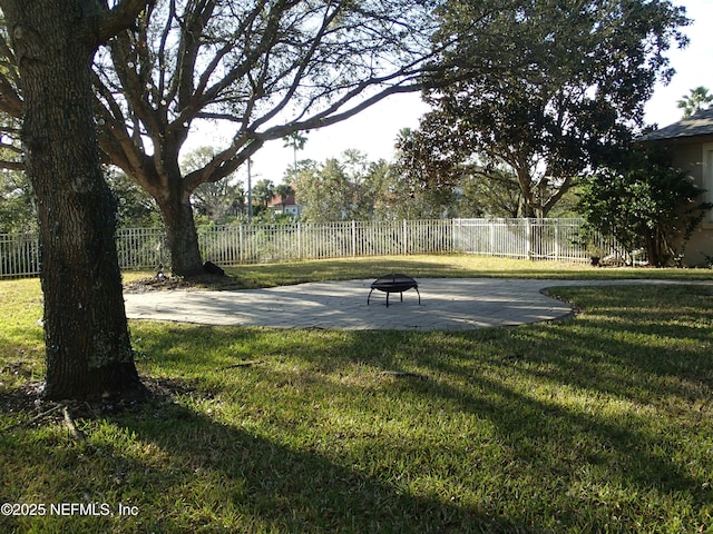 view of home's community featuring an outdoor fire pit, a patio area, a lawn, and a fenced backyard