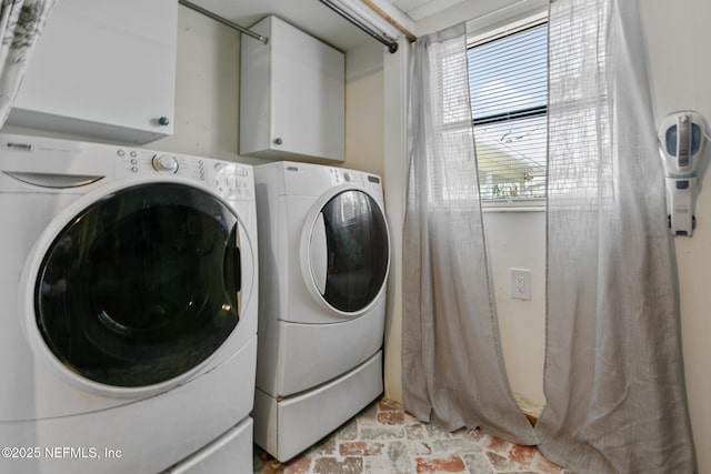 laundry area featuring washer and dryer and cabinets