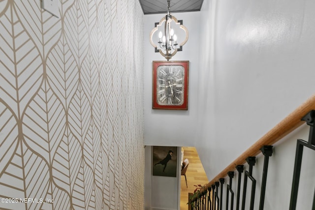 staircase featuring a chandelier