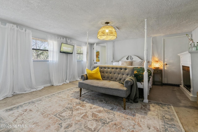 bedroom featuring carpet flooring and a textured ceiling