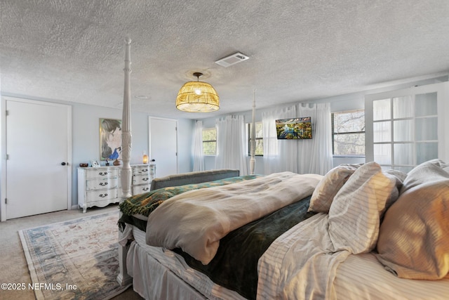 carpeted bedroom featuring a textured ceiling