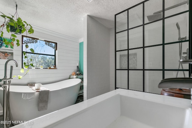 bathroom with separate shower and tub and a textured ceiling