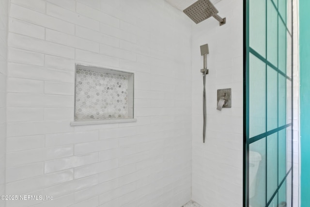 bathroom with a tile shower