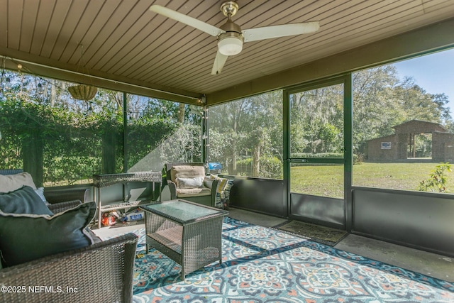 sunroom / solarium featuring ceiling fan