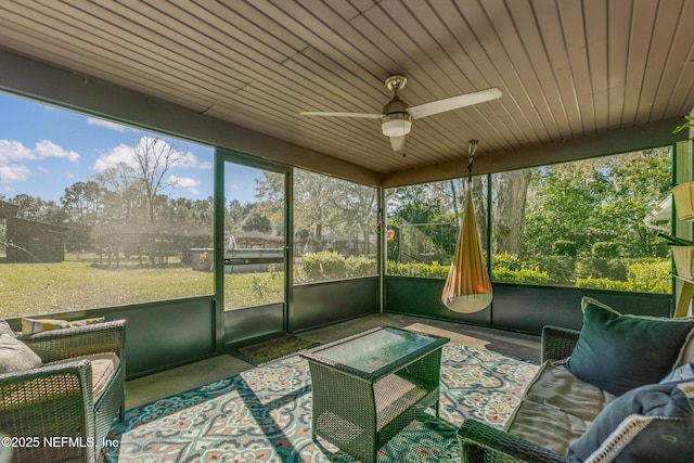 unfurnished sunroom with ceiling fan