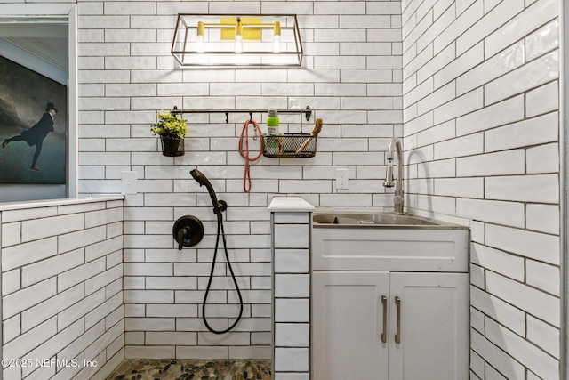 bathroom featuring sink and a tile shower