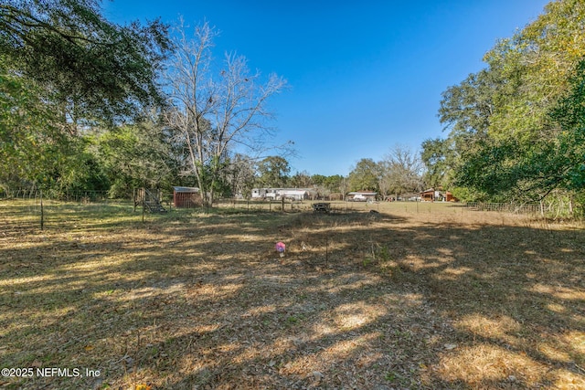 view of yard with a rural view