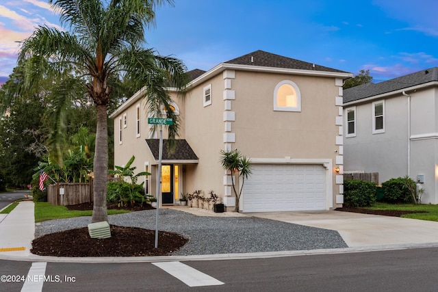 mediterranean / spanish-style home with a garage