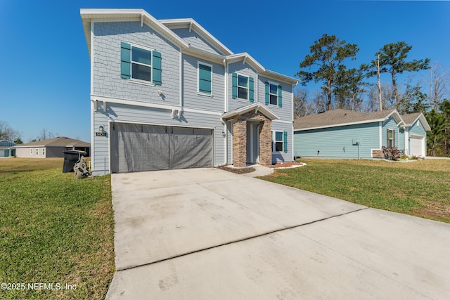 view of front facade with a garage, driveway, and a front lawn