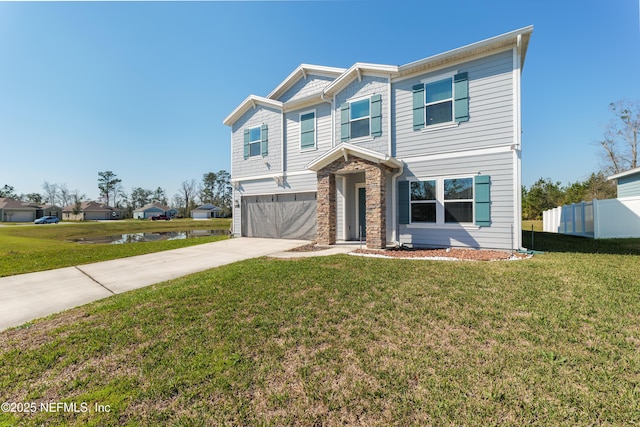 view of front of property with a garage, fence, driveway, stone siding, and a front yard