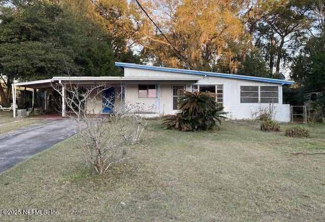 view of front of home with a front yard and stucco siding