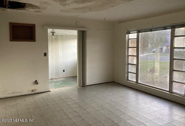 unfurnished room featuring a ceiling fan