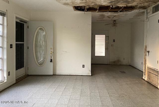 spare room featuring ceiling fan and light floors