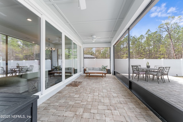 sunroom featuring ceiling fan and a healthy amount of sunlight