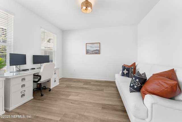 office with light wood-style flooring and baseboards