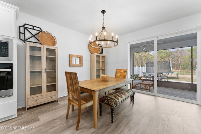 dining space featuring a chandelier and light wood finished floors