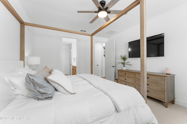 bedroom featuring connected bathroom, light carpet, visible vents, baseboards, and a ceiling fan