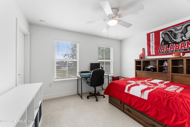 carpeted bedroom with ceiling fan and baseboards