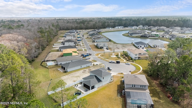 drone / aerial view with a water view and a residential view