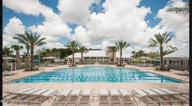 community pool featuring a patio area and fence