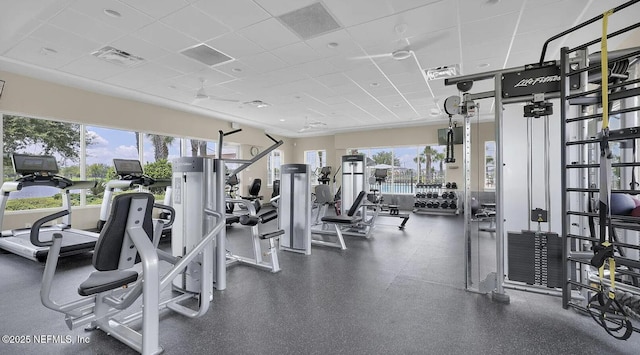 gym with a paneled ceiling and visible vents