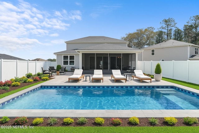 back of property featuring a fenced backyard, a sunroom, a patio, and a fenced in pool