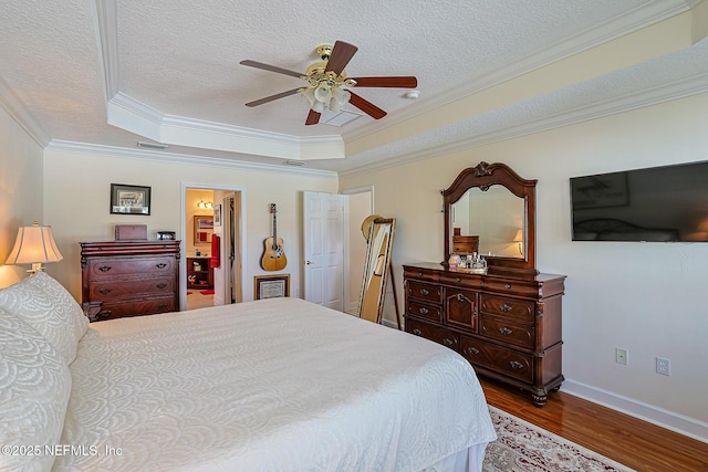 3383 Olympic Dr, Green Cove Springs, FL 32043 - bedroom with a tray ceiling, ornamental molding, a textured ceiling, and wood finished floors