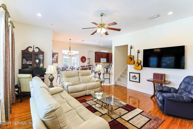 3383 Olympic Dr, Green Cove Springs, FL 32043 - living area with ceiling fan with notable chandelier, stairs, baseboards, light wood-style floors, and recessed lighting