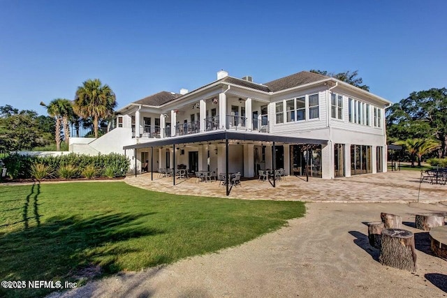 3383 Olympic Dr, Green Cove Springs, FL 32043 - rear view of property with a patio area, a balcony, ceiling fan, a chimney, and a lawn