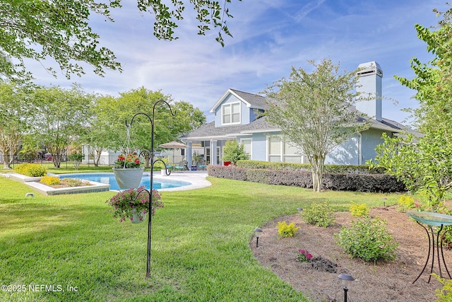 3383 Olympic Dr, Green Cove Springs, FL 32043 - back of house with a patio area, a fenced in pool, a lawn, and a fenced backyard