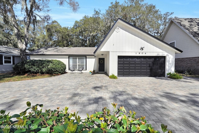 view of front facade featuring an attached garage and decorative driveway