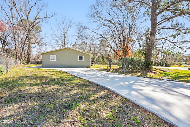 10605 Arnez Rd, Jacksonville, FL 32218 - view of side of property with fence and a lawn