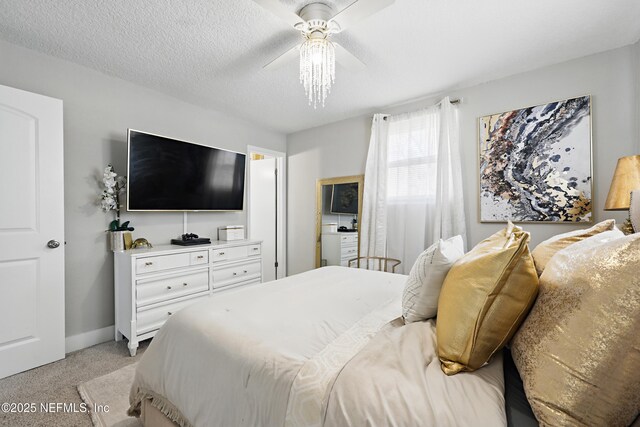 10605 Arnez Rd, Jacksonville, FL 32218 - bedroom with light carpet, ceiling fan, baseboards, and a textured ceiling