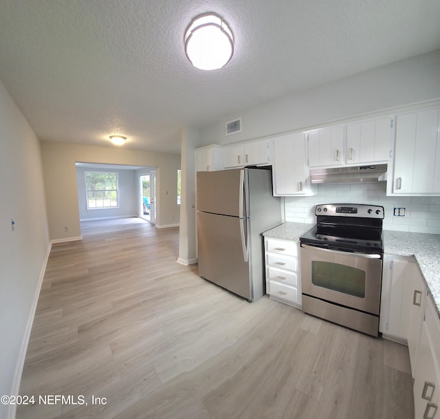 kitchen featuring backsplash, white cabinets, and stainless steel appliances